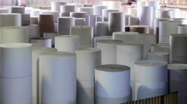 Rolls of paper for further processing. Factory making paper.