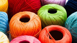 Colorful yarn of balls background. Bright knitting thread texture. Handiwork, leisure, hobby concept